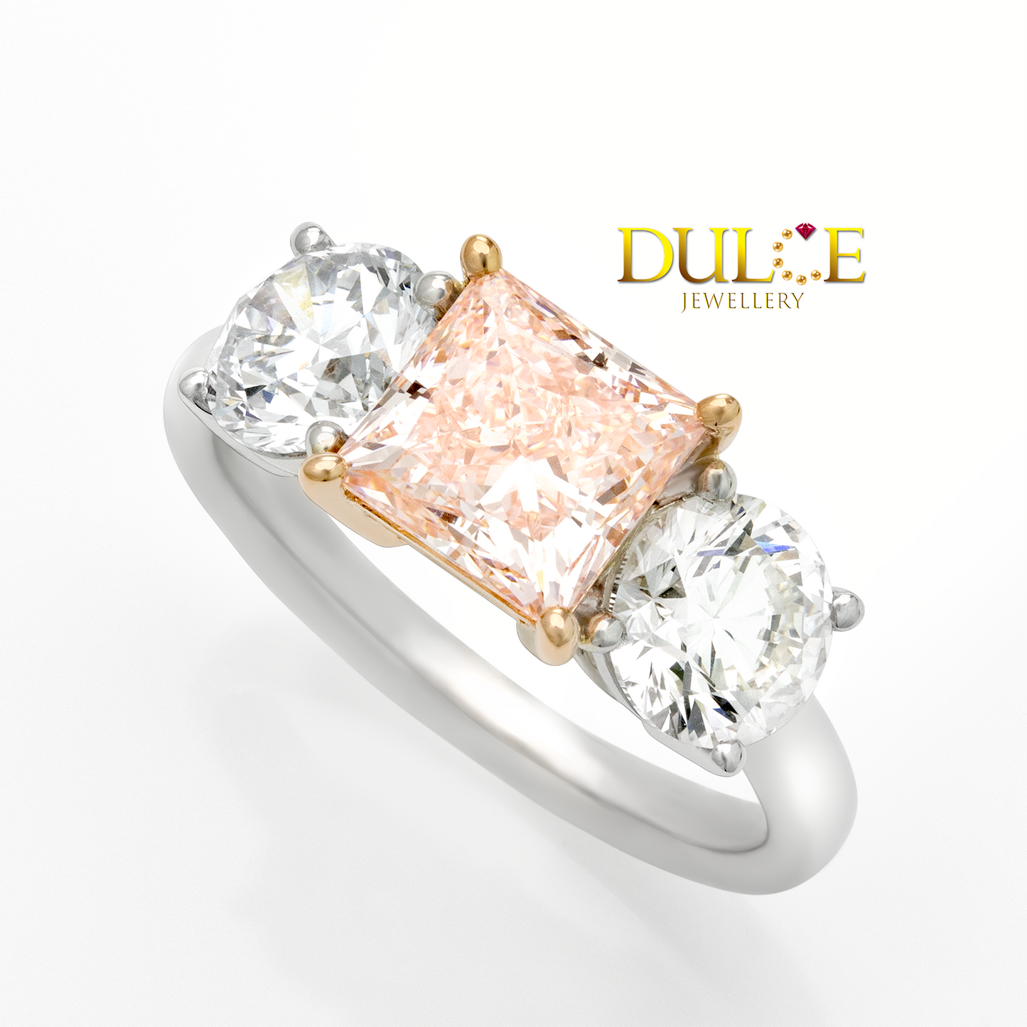 Diamond ring with a fancy vivid pink diamond and two round diamonds, branded 'Dulce Jewellery'.