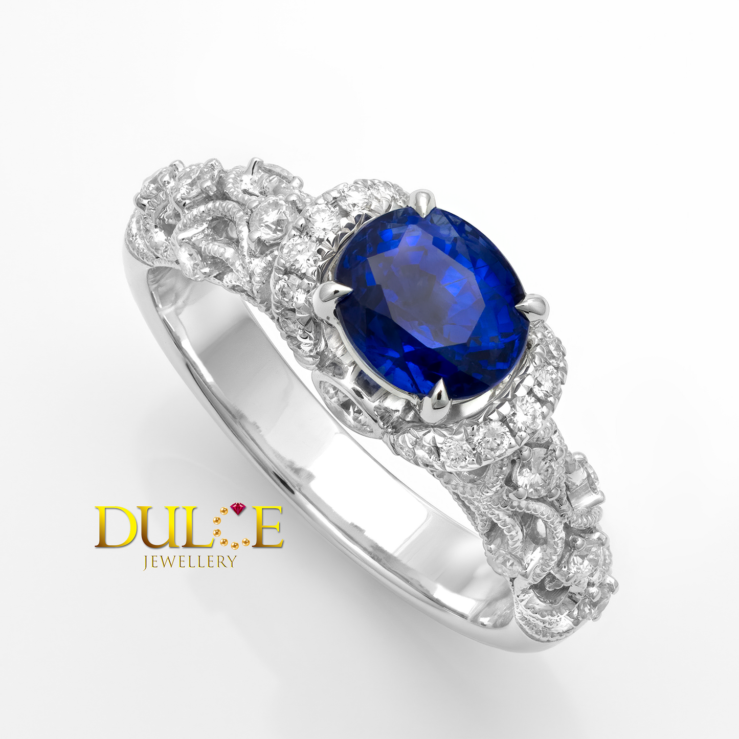 14K gold ring with a blue sapphire gemstone and diamond accents on a white background, branded 'Dulce Jewellery'.