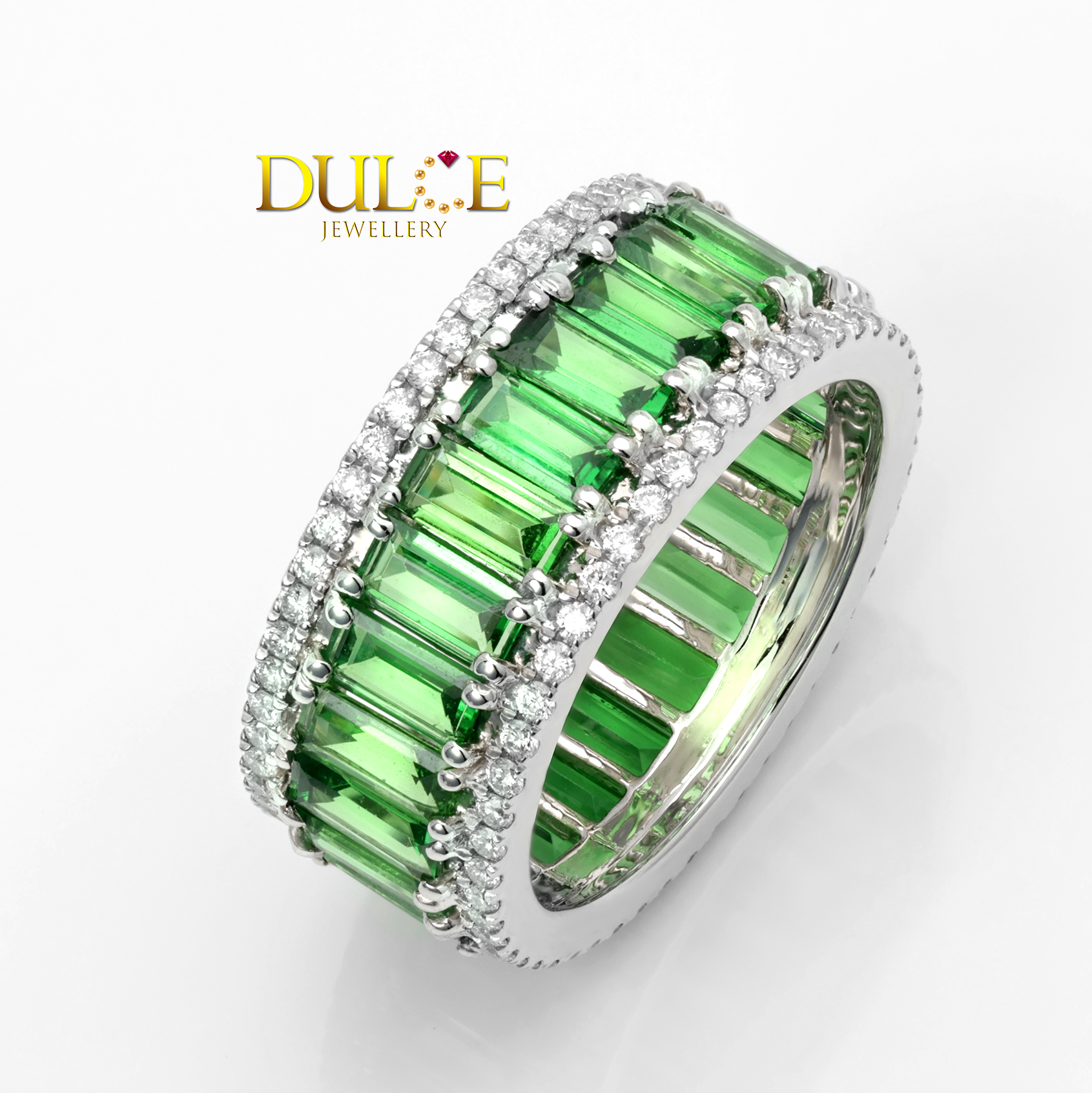 Green tsavorite gemstone ring with 18k gold border on a white background, featuring the Dule Jewellery logo.