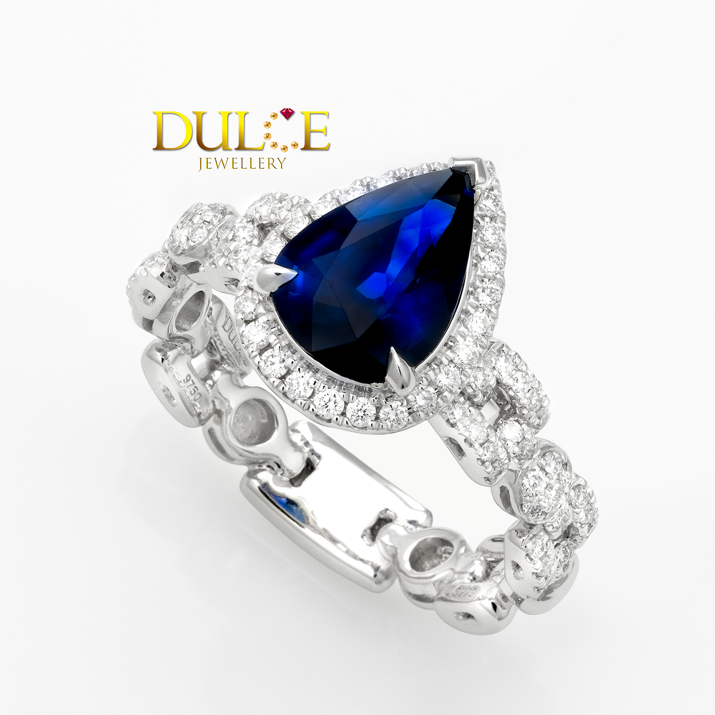 Platinum ring with a blue sapphire gemstone and 'Dulce Jewellery' logo on a white background