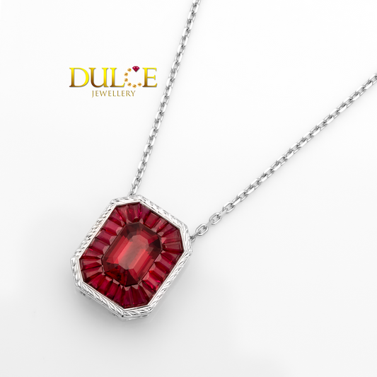 Jewelry necklace with a red spinel gemstone pendant on a white background, featuring the Dulie Jewellery logo.