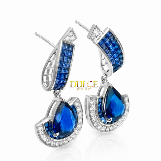 Blue teardrop earrings with silver detailing on a white background, featuring the Dulce Jewellery brand.