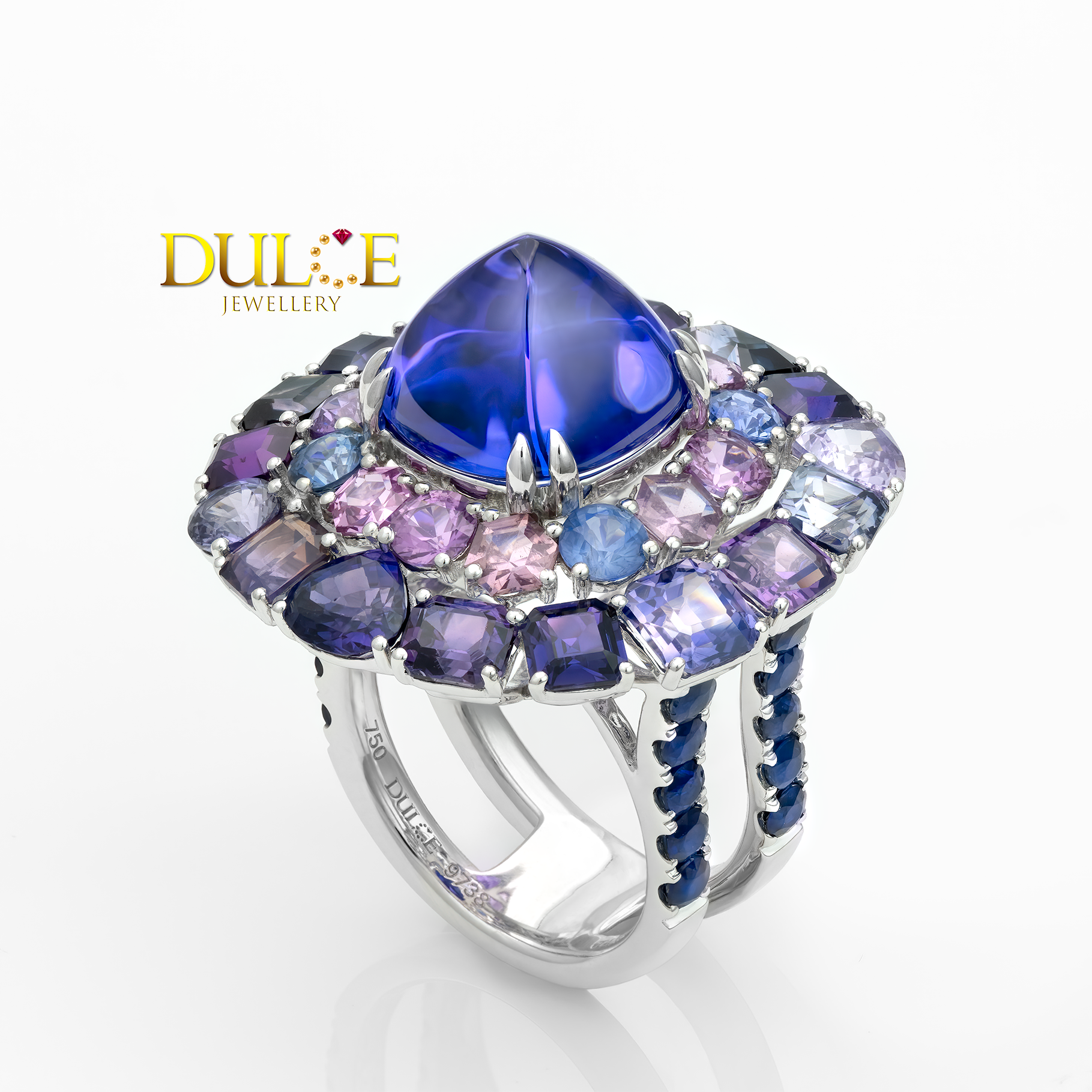 Multicolored gemstone ring with a blue central stone on a white background, featuring the Dulice Jewellery logo.