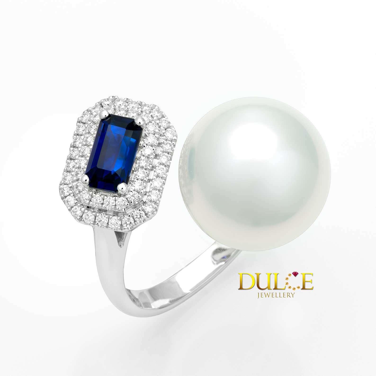 Ring with blue gemstone and pearl on a white background, featuring Dulce Jewellery logo.