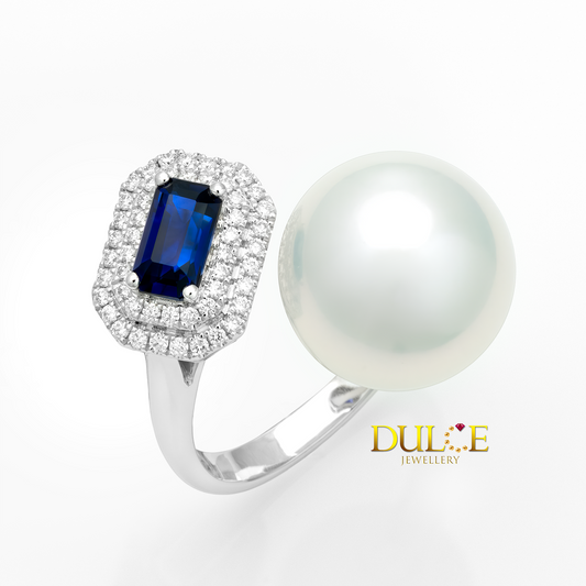 Ring with blue gemstone and pearl on a white background, featuring Dulce Jewellery logo.