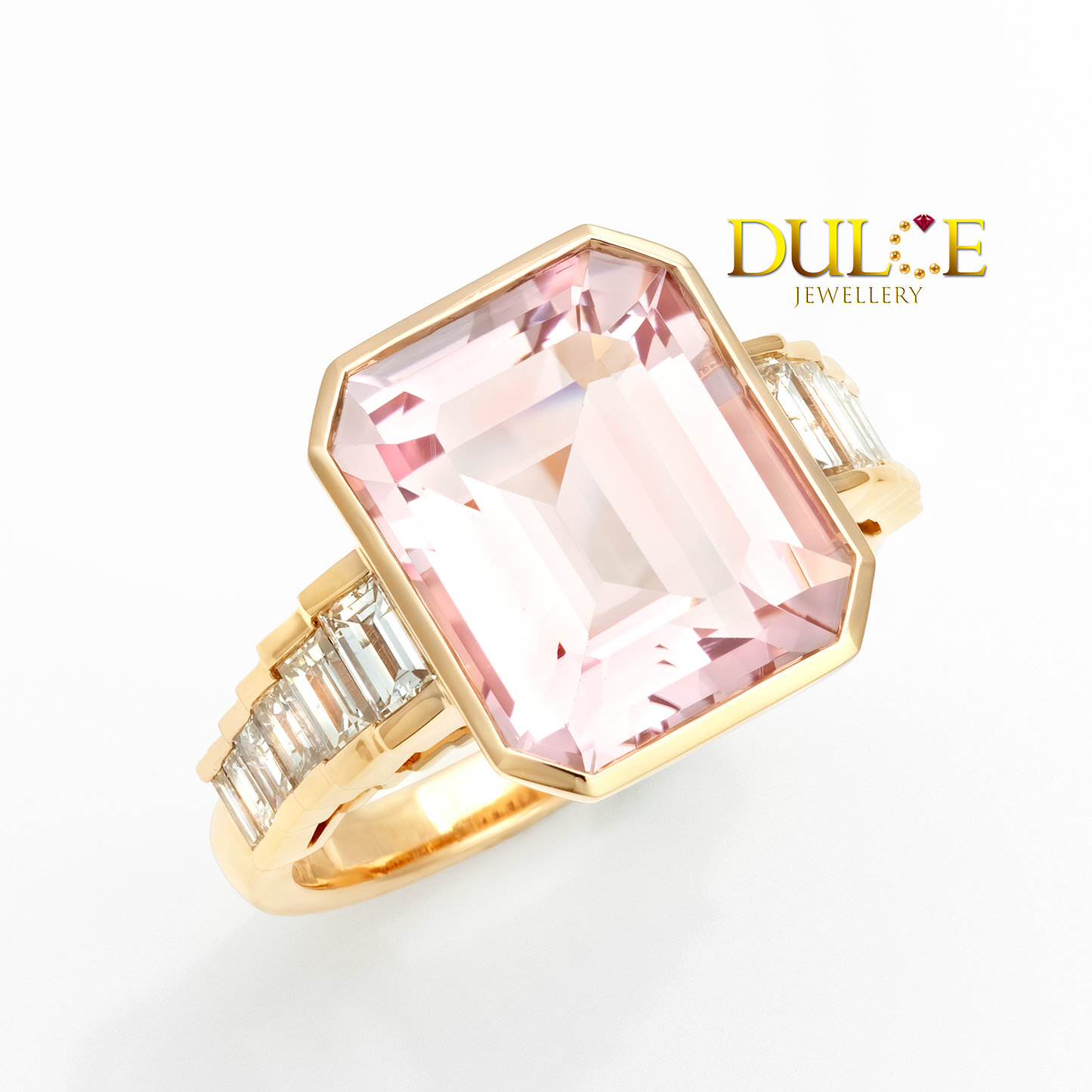 Gold ring with a pink gemstone on a white background, featuring the Dulce Jewellery logo.