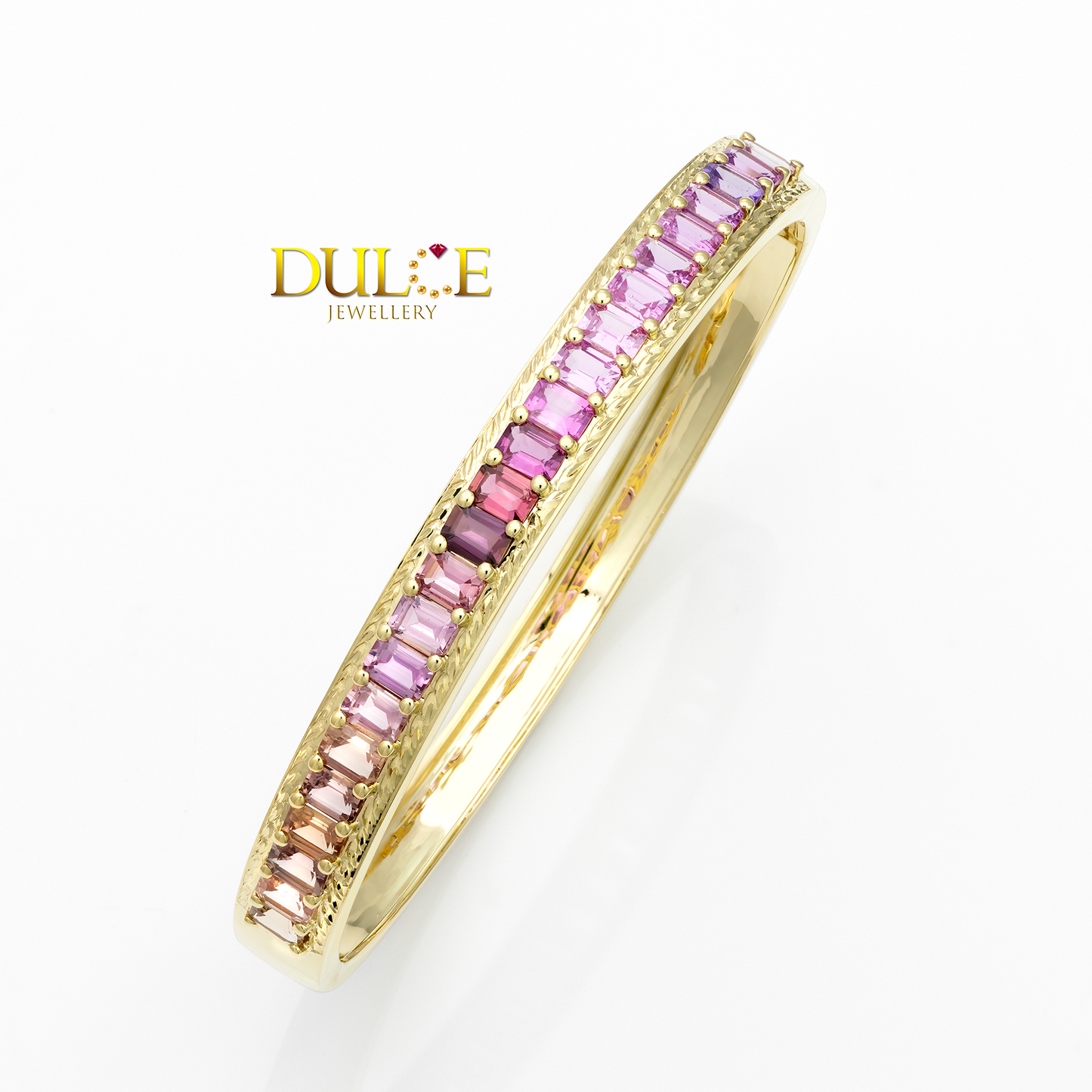 Gold ring with pink gemstones on a white background, featuring the brand 'Dulce Jewellery'.