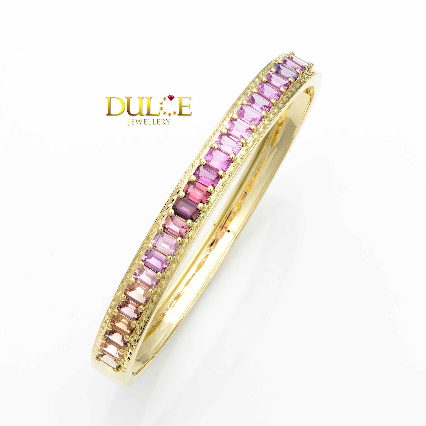 Gold ring with pink gemstones on a white background, featuring the brand 'Dulce Jewellery'.