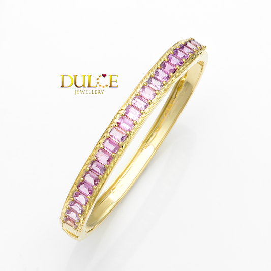 Gold bracelet with pink gemstones on a white background, featuring the brand 'Dulce Jewellery'.