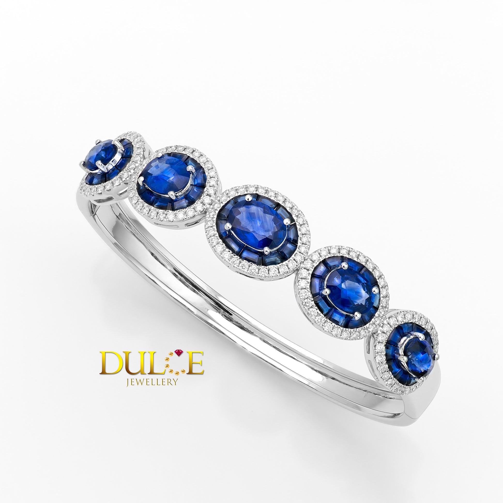 Gold bracelet with blue gemstones on a white background, featuring the Dulce Jewellery logo.