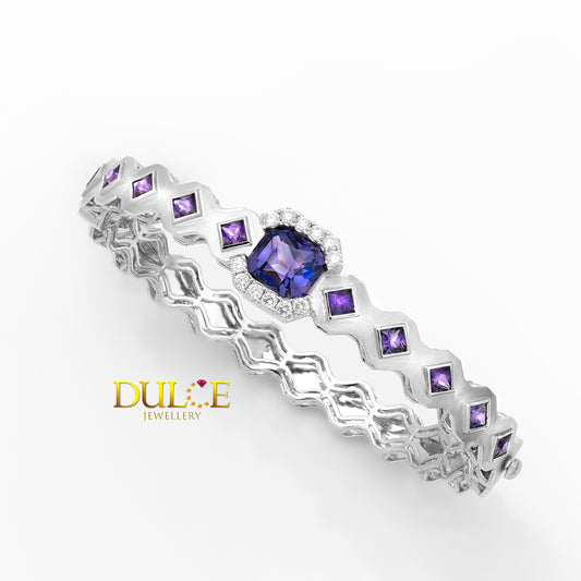 Gold Bangle with purple gemstones on a white background, featuring the Dulee Jewellery logo.